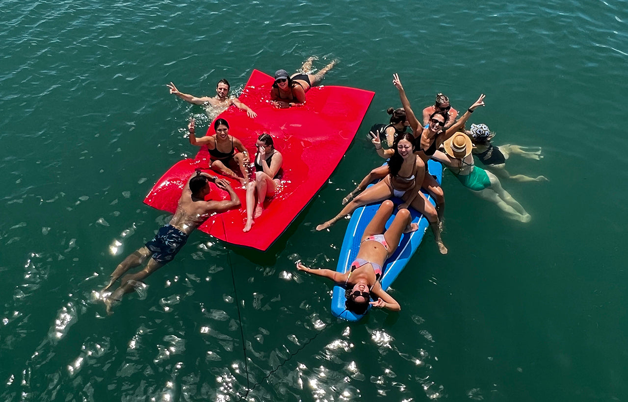 Luxury Charter guests enjoying AQUAHOLIC's watertoys, watermat and stand-up paddleboards