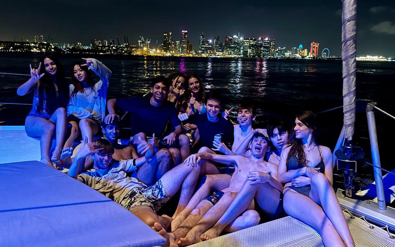 Guests on bow of AQUAHOLIC with Singapore City Skyline in background