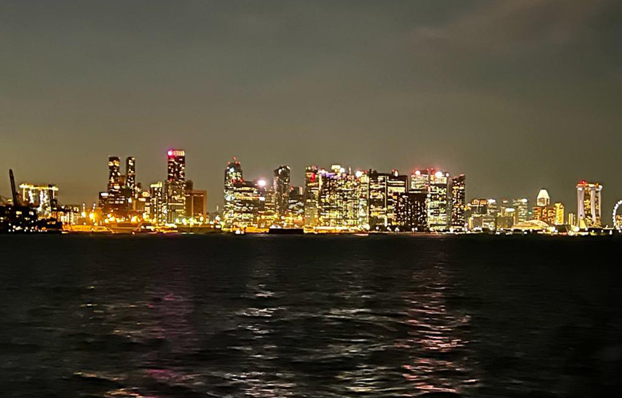 Lights of Singapore city skyline from stern of AQUAHOLIC