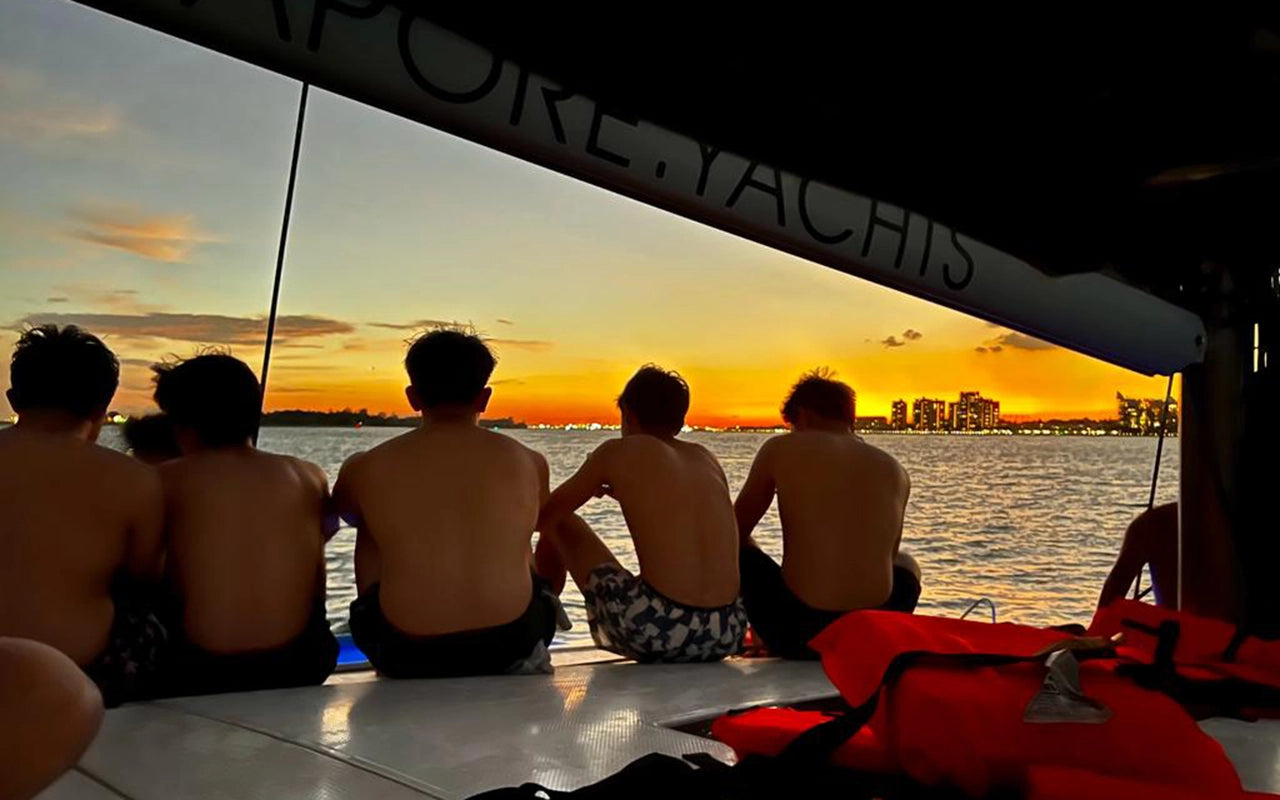 Group of guests watching a Sunset on AQUAHOLIC Yacht Charter