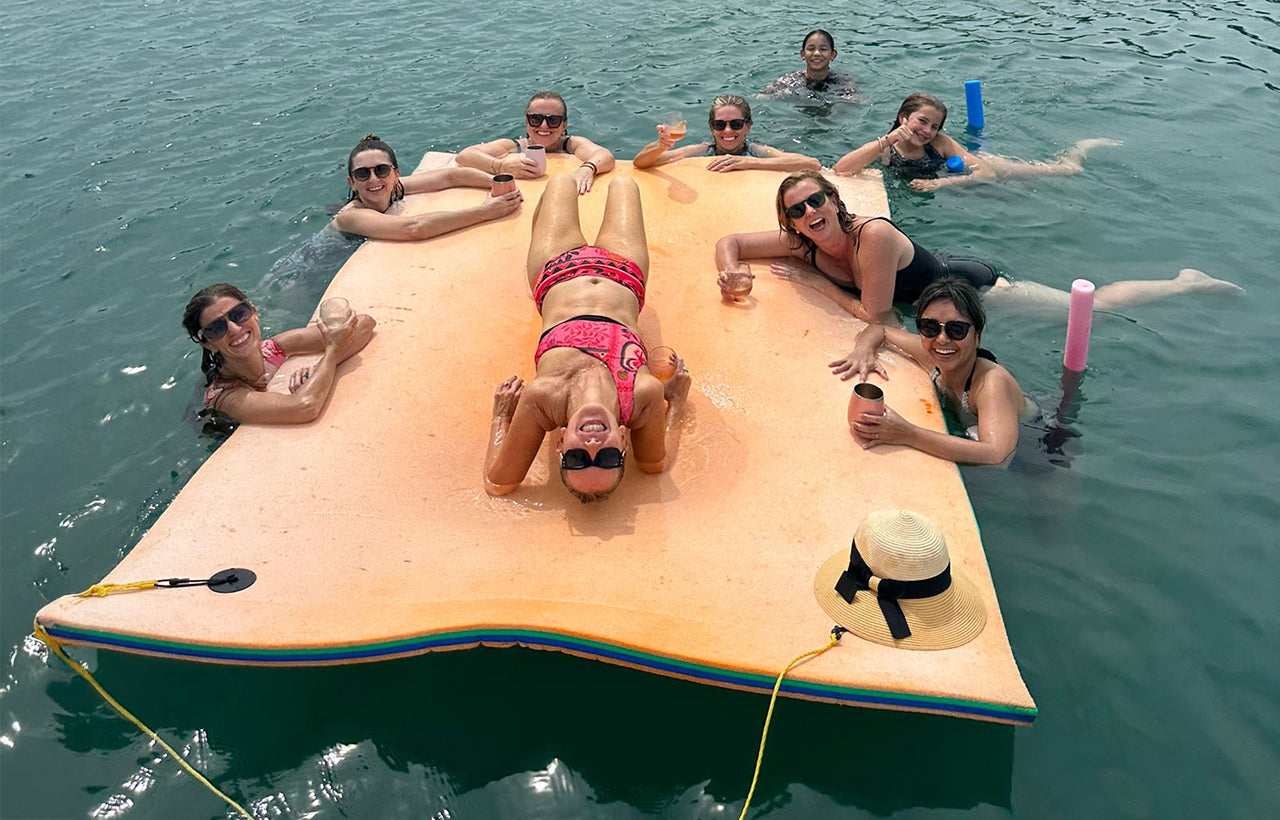 Aquaholic guests enjoying drinks on AQUAHOLIC's watermat