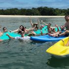 AQUAHOLIC -Group on Kayak, Standup Paddleboard & Watermat Enjoying The Sun & Sea